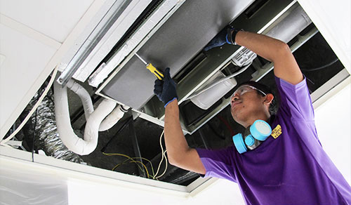 we will fix it employee cleaning the ac coil