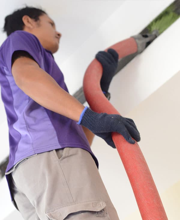 We will fix it employee cleaning air conditioner duct with big pipe