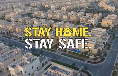 Stay home stay safe label with houses in background