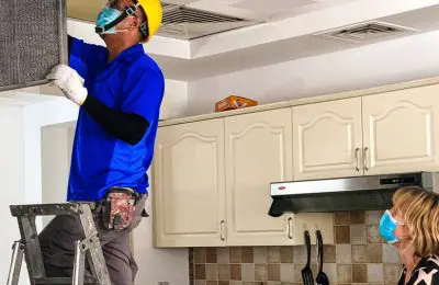 We will fix it employee cleaning kitchen air conditioning unit