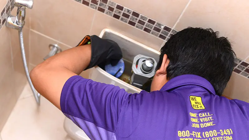 We will fix it employee fixing water tank of toilet