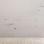 Hardwood white floor with a dirty wall