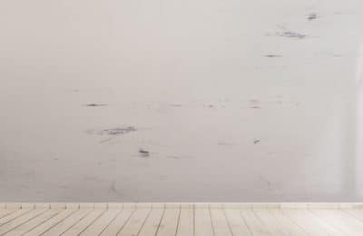 Hardwood white floor with a dirty wall