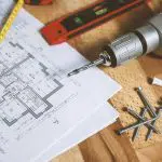 House blueprint with tools and drill machine