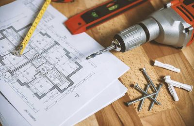 House blueprint with tools and drill machine