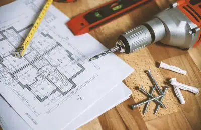 House blueprint with tools and drill machine