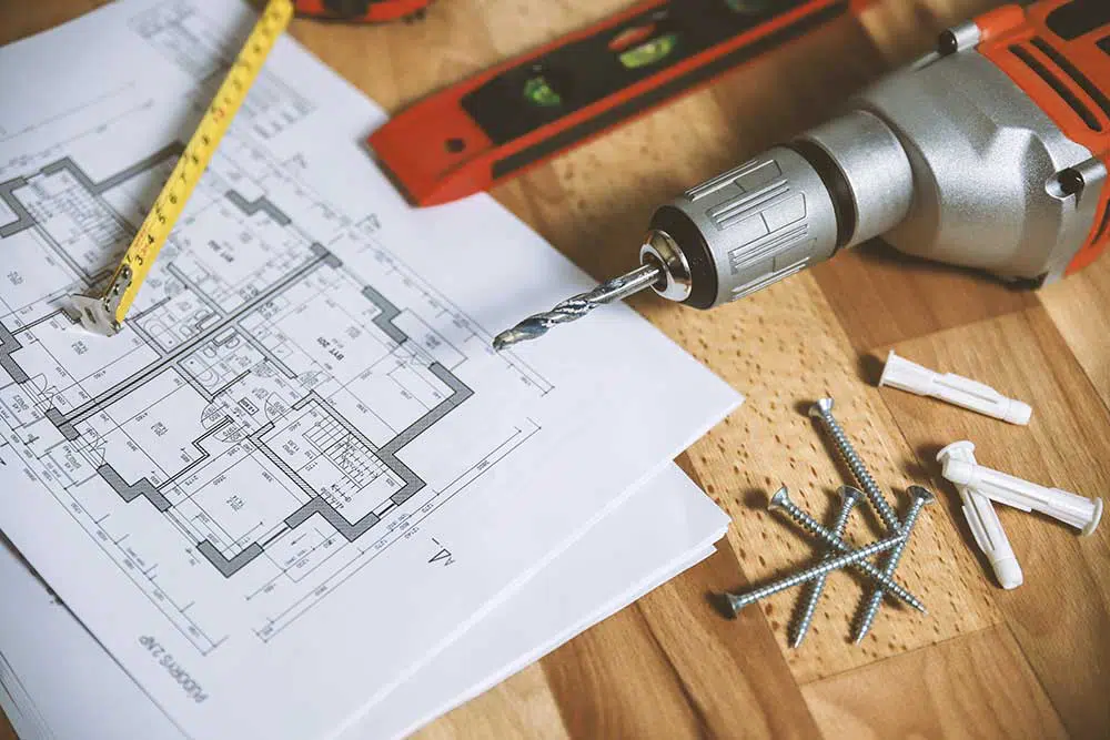 House blueprint with tools and drill machine