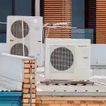 Two AC units placed on a metal sheet