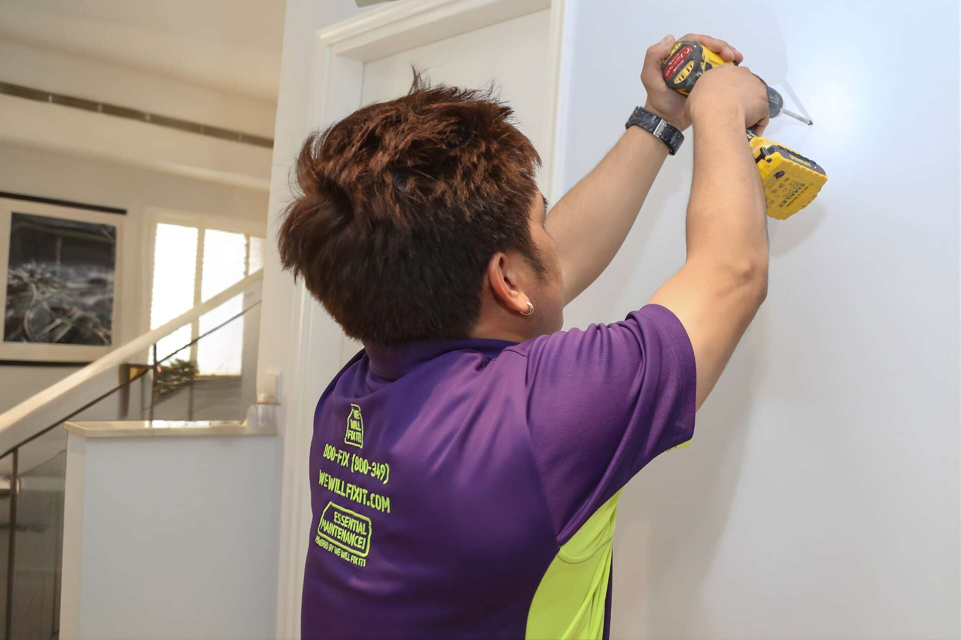 Tech Holding Drill Against A Wall