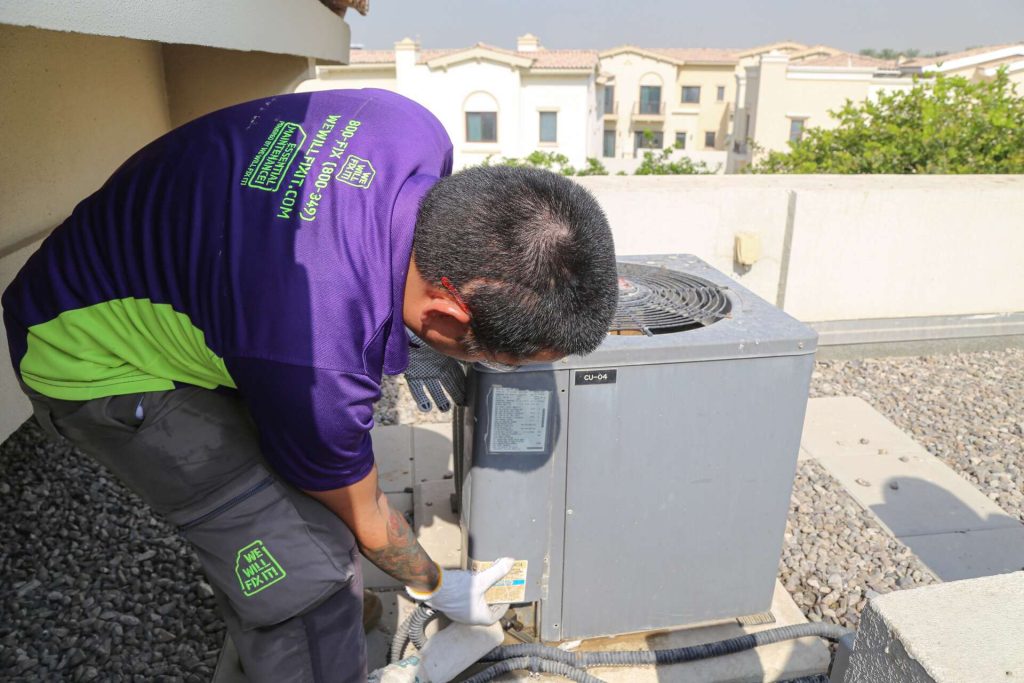 Tech Working On Ac Roof